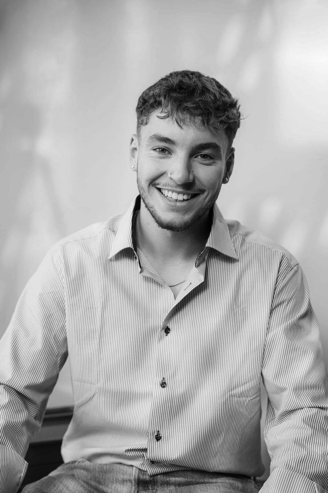 Moritz, Social Media Manager at SAM Innovate, laughing into the camera in a light shirt
