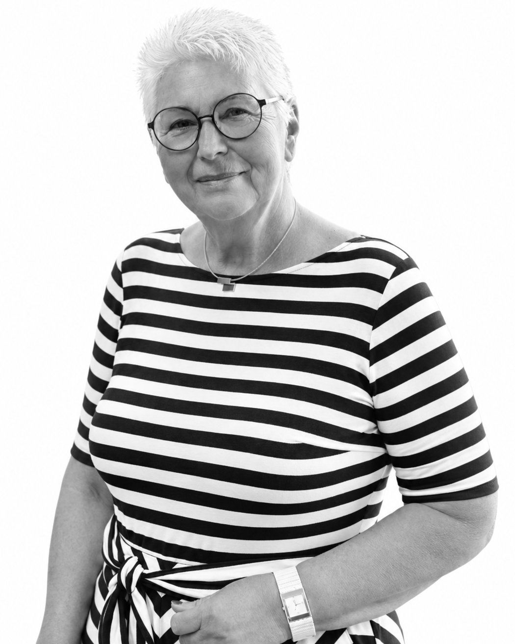Eva Maria, Head of PR and Strategic Relations at SAM Innovate, smiling in a striped dress