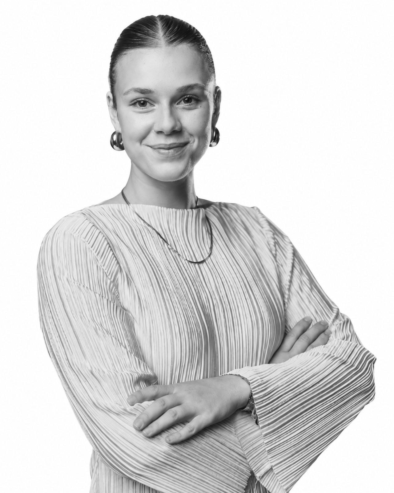 Veronika (Vroni), designer and photographer at SAM Innovate, smiling with arms crossed