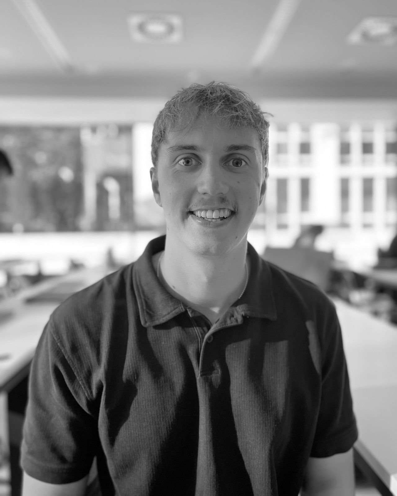 Simon, customer success and technical support at SAM Innovate, smiling in the office