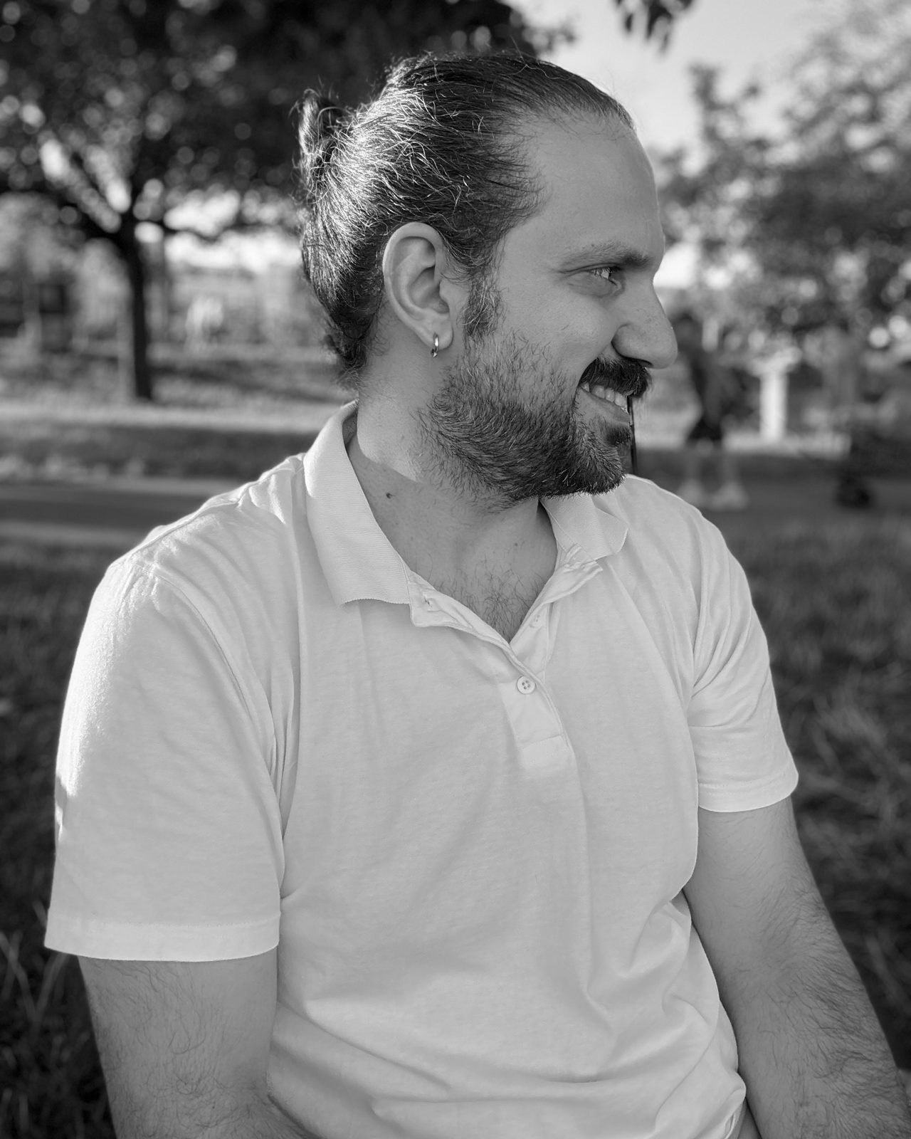 Mustafa, performance marketing at SAM Innovate, smiling outdoors in a white polo shirt